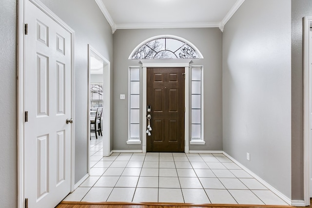 entryway with crown molding and light tile patterned flooring