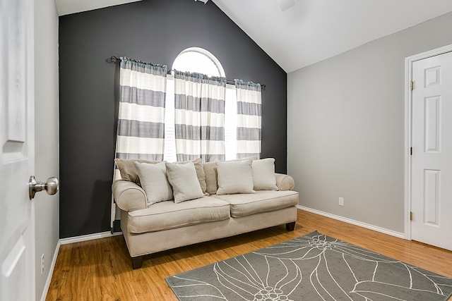 living room featuring hardwood / wood-style floors and vaulted ceiling