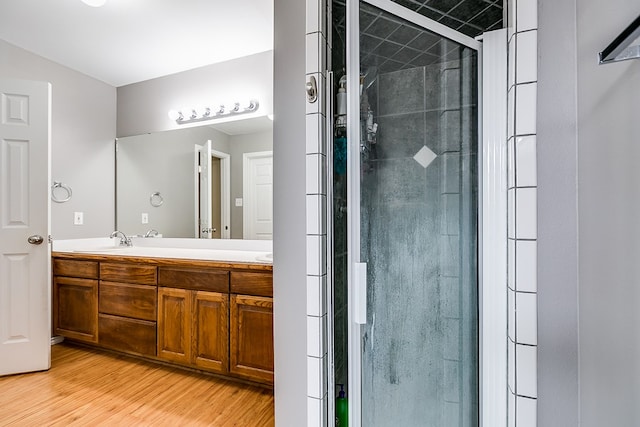 bathroom with vanity, wood-type flooring, and walk in shower