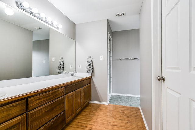 bathroom featuring hardwood / wood-style flooring and vanity