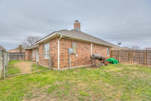 view of side of property with a lawn