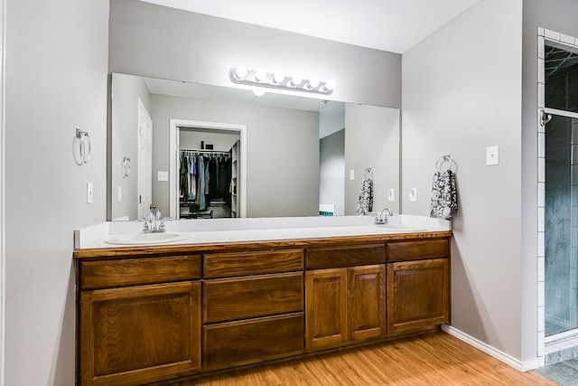 bathroom featuring an enclosed shower, vanity, and hardwood / wood-style flooring