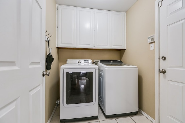 washroom with light tile patterned floors, cabinets, and independent washer and dryer