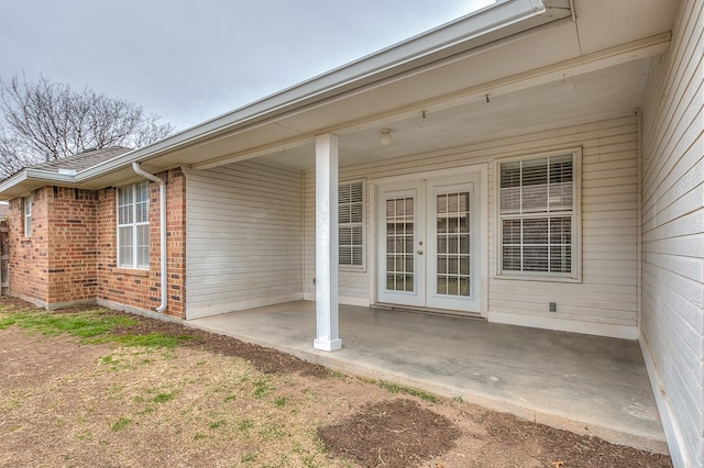 property entrance featuring a patio area and french doors