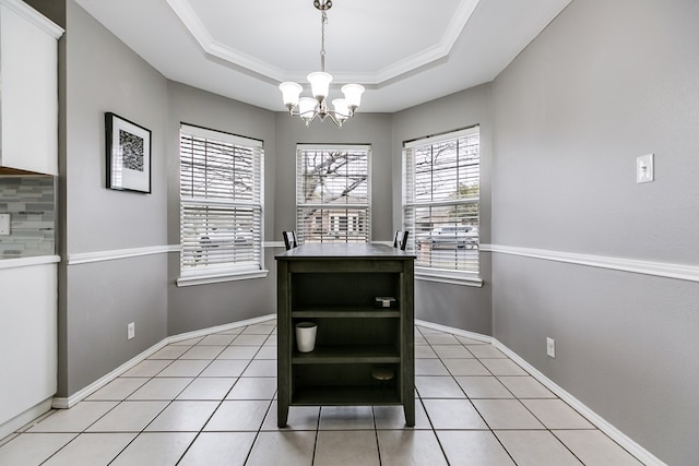 dining space featuring crown molding, a raised ceiling, light tile patterned floors, and a notable chandelier