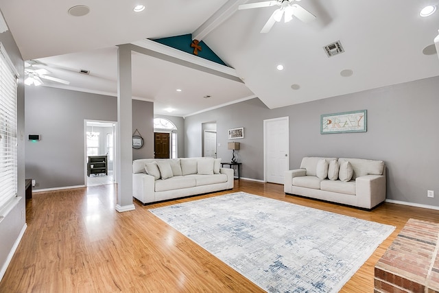 living room with ceiling fan, wood-type flooring, beam ceiling, and ornamental molding