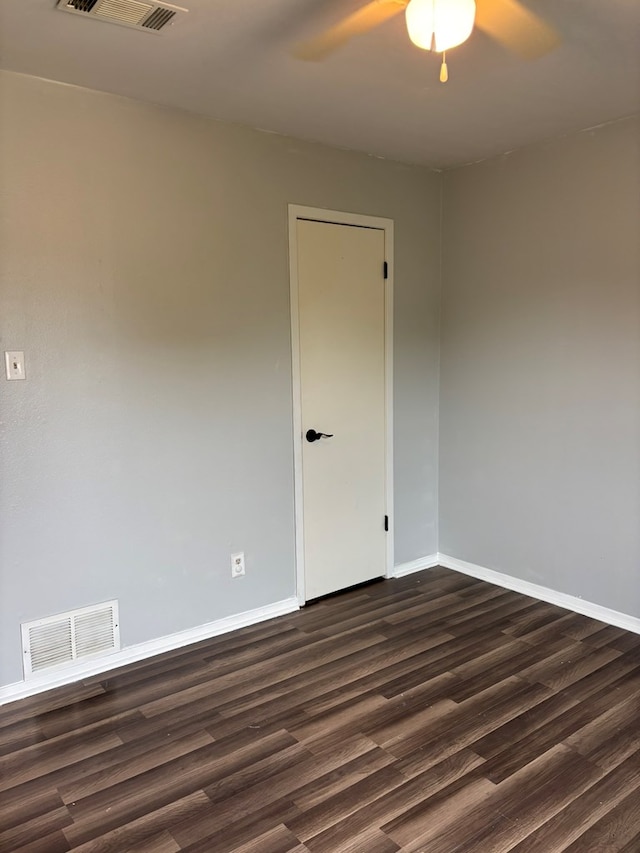 1014 Alpha Cir, San Angelo, TX 76903 - spare room with dark wood-style floors, ceiling fan, and baseboards