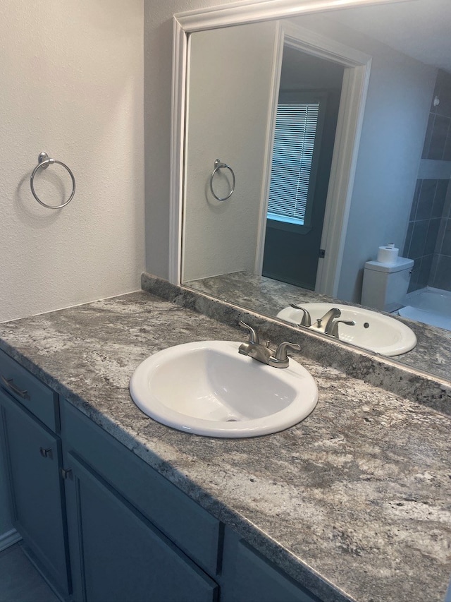 bathroom featuring vanity and toilet