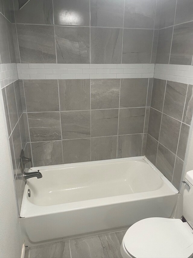 bathroom with shower / bath combination and toilet