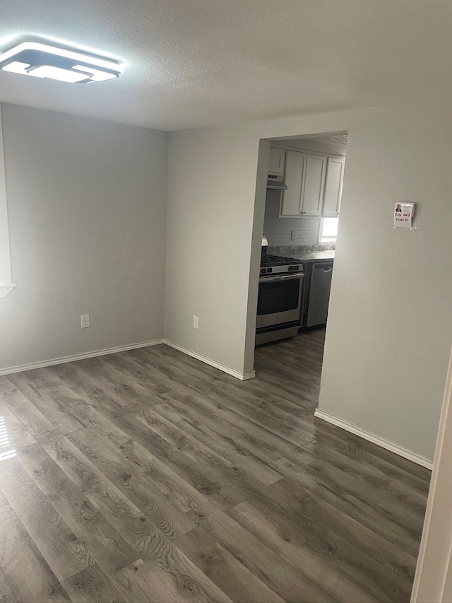 unfurnished living room featuring dark hardwood / wood-style floors and a textured ceiling