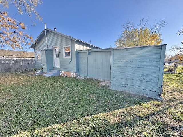 rear view of property with a yard