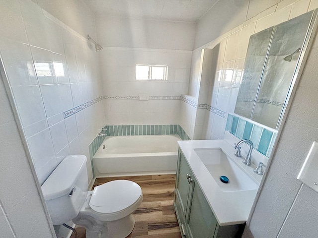 full bathroom with hardwood / wood-style flooring, vanity, plus walk in shower, and toilet