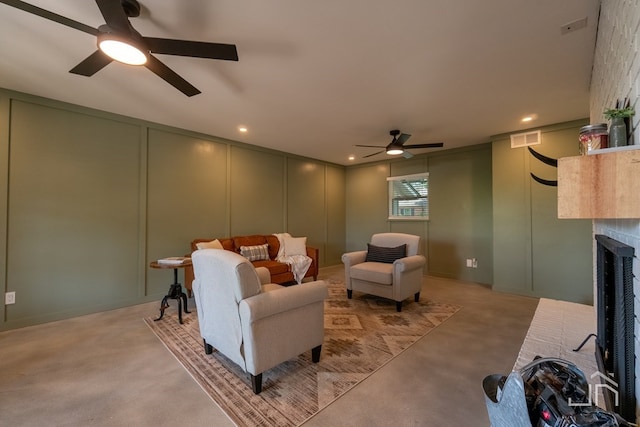2301 Sul Ross St, San Angelo, TX 76904 - living room with visible vents, light colored carpet, a ceiling fan, a decorative wall, and a fireplace