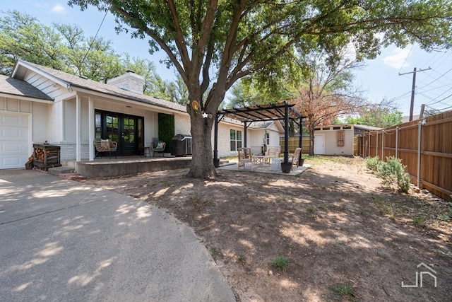 2301 Sul Ross St, San Angelo, TX 76904 - exterior space with a chimney, a fenced backyard, a storage shed, an outdoor structure, and brick siding