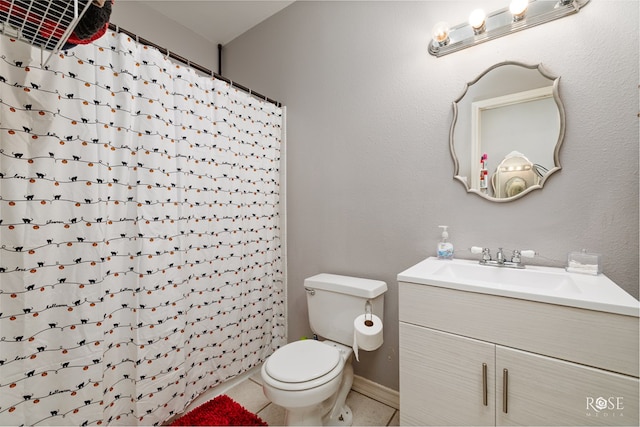 bathroom featuring vanity, a shower with shower curtain, tile patterned floors, and toilet