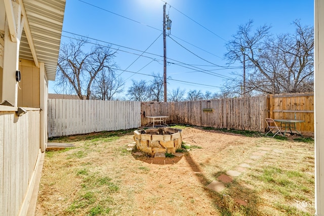 view of yard with an outdoor fire pit