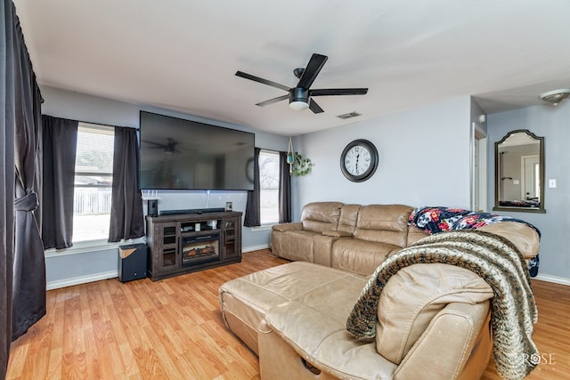 living room with ceiling fan and light wood-type flooring