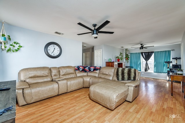 living room featuring hardwood / wood-style flooring and ceiling fan