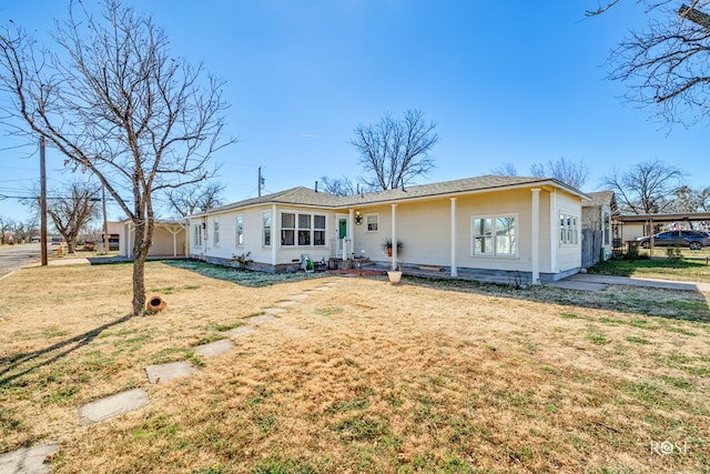 ranch-style home featuring a front yard