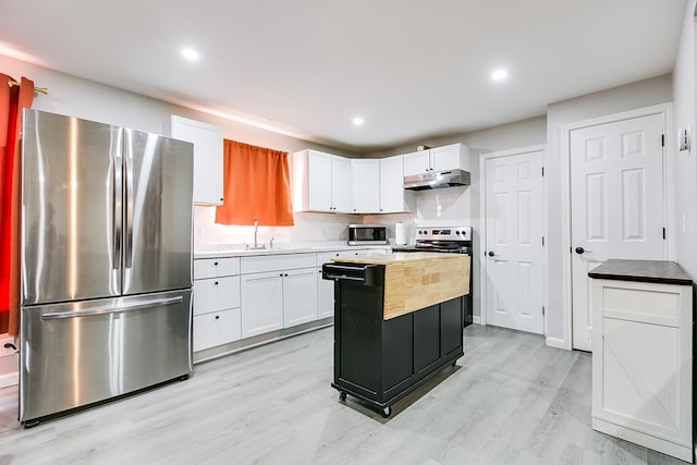 kitchen featuring under cabinet range hood, white cabinets, appliances with stainless steel finishes, and light wood-style floors