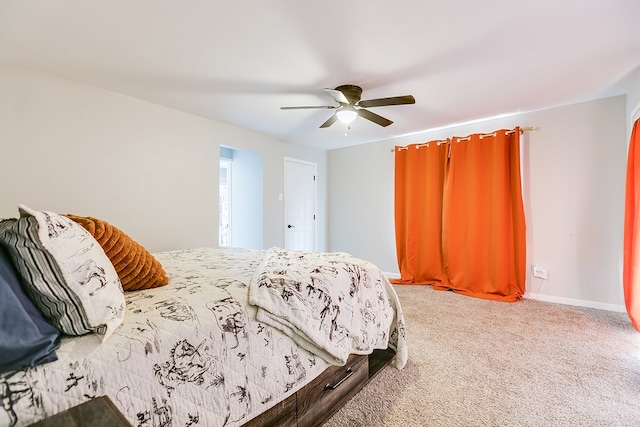 carpeted bedroom with baseboards and ceiling fan