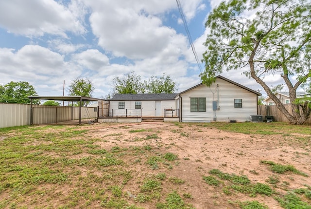 back of property featuring central air condition unit, a fenced backyard, and a deck