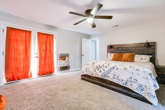 carpeted bedroom featuring visible vents, baseboards, and ceiling fan