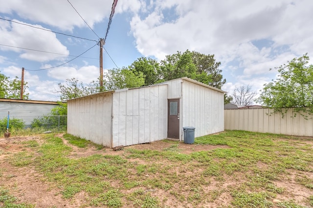 view of outbuilding featuring an outbuilding and fence