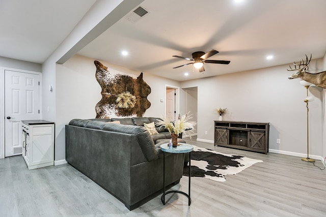 living room featuring recessed lighting, light wood-style flooring, and baseboards