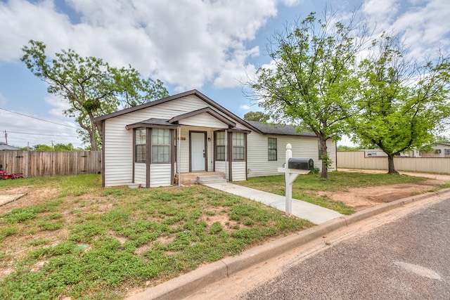 view of front of property with fence and a front yard
