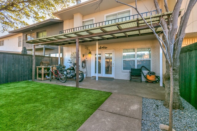 back of house featuring a yard and a patio area