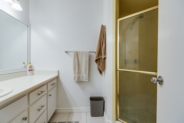 bathroom featuring an enclosed shower, vanity, and tile patterned flooring