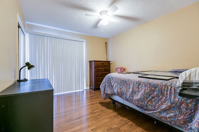 bedroom with wood-type flooring, a textured ceiling, and ceiling fan