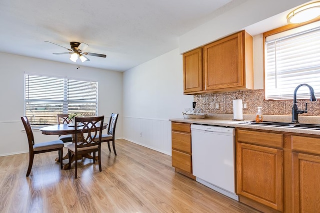 kitchen featuring a sink, dishwasher, ceiling fan, and a healthy amount of sunlight