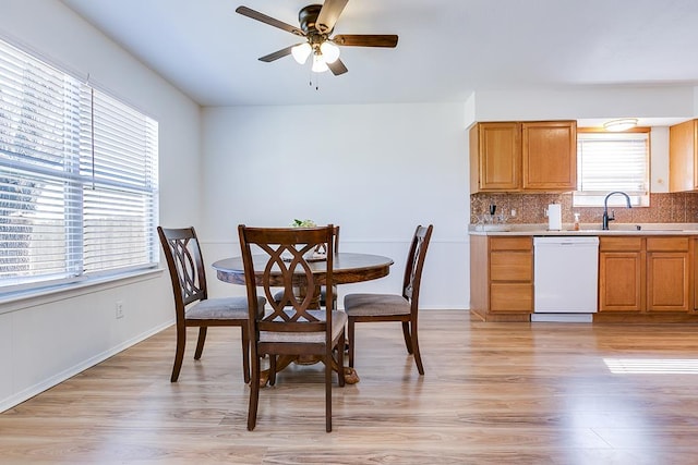 dining room featuring light wood-style floors and a ceiling fan