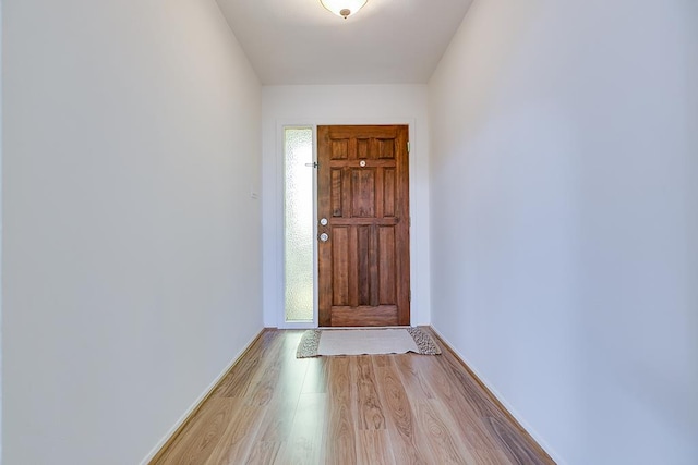 entryway with baseboards and light wood-type flooring