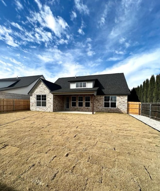 1958 Beaty Rd, San Angelo, TX 76904 - view of front facade featuring a fenced backyard and stone siding