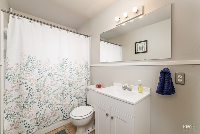 full bathroom with tile patterned floors, curtained shower, toilet, and vanity