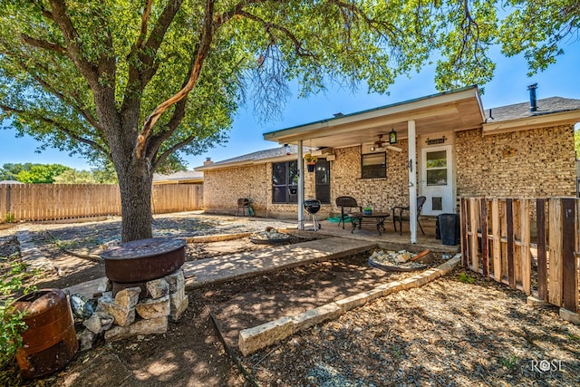 1216 Ricks Ct, San Angelo, TX 76905 - back of property with a patio, a fenced backyard, and a ceiling fan