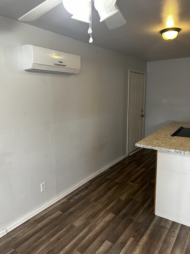 interior space with dark hardwood / wood-style flooring and an AC wall unit