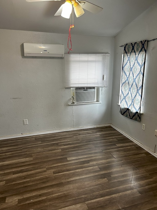 unfurnished room with cooling unit, ceiling fan, dark wood-type flooring, and a wall unit AC