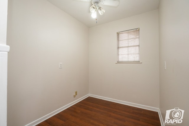 spare room with dark hardwood / wood-style floors and ceiling fan