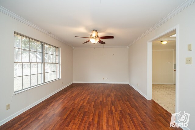 empty room featuring dark hardwood / wood-style flooring, ornamental molding, and ceiling fan