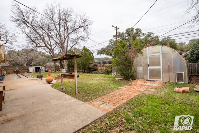 view of yard featuring an outbuilding and a patio