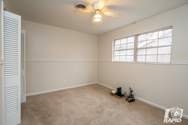 unfurnished room featuring light carpet and ceiling fan