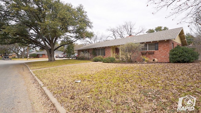 ranch-style home featuring a front yard