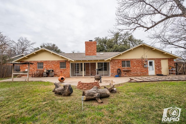 rear view of house with a lawn and a patio