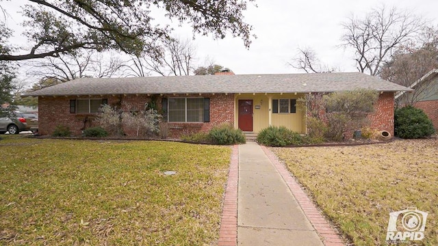 single story home featuring a front lawn