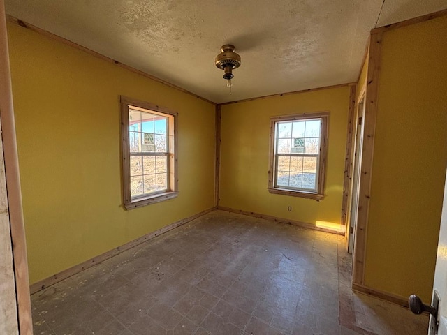 spare room with a textured ceiling