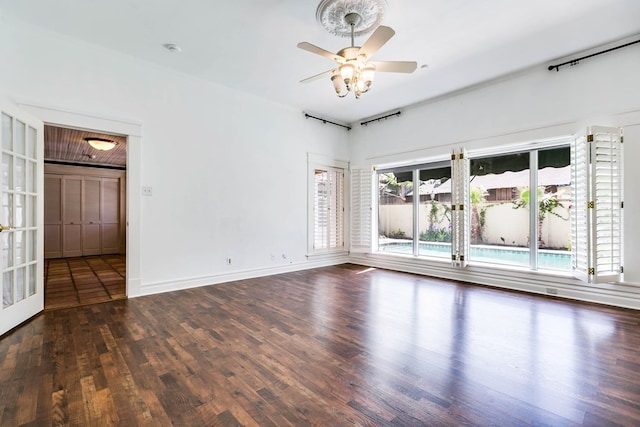 unfurnished room with dark hardwood / wood-style flooring and ceiling fan